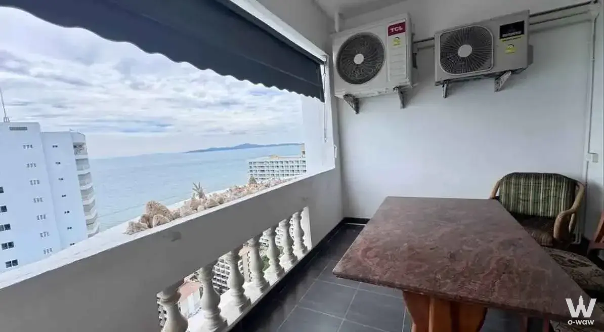 Functional balcony at Jomtien Complex Condotel with awning, seating, and distant ocean horizon views