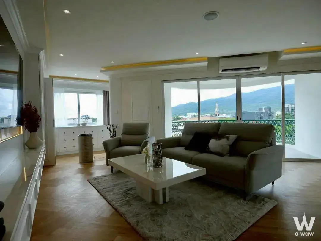 Luxury living room with grey sofa and balcony mountain view in Hillside Condo 4 3-bed unit