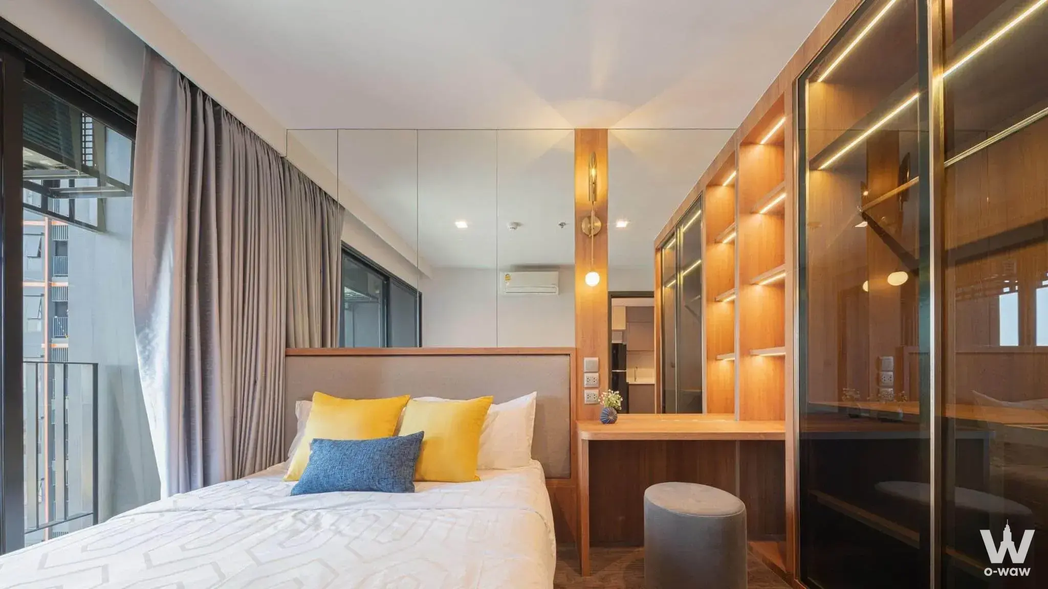 Bedroom in a 1-bed rental at Life Ladprao Valley featuring a queen bed, glass wardrobe, and floor-to-ceiling window