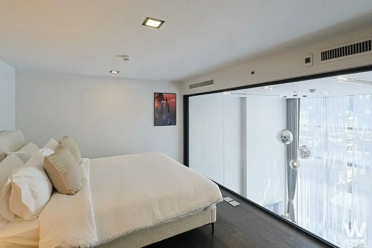 Master bedroom in CONNER Ratchathewi with high-floor city view and mirrored closet panels