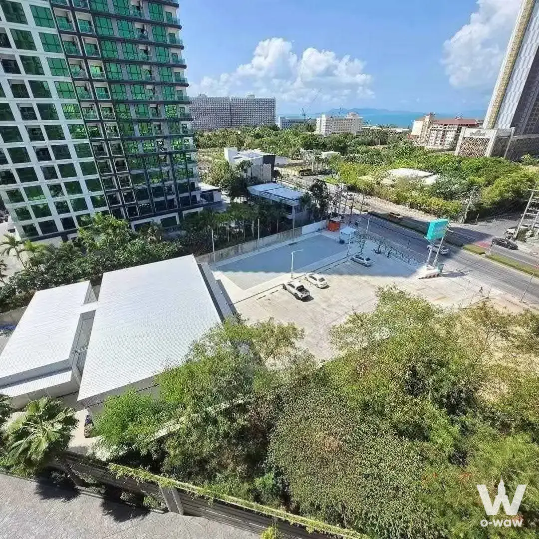 High-floor view from The Riviera Ocean Drive showing tropical greenery and ocean