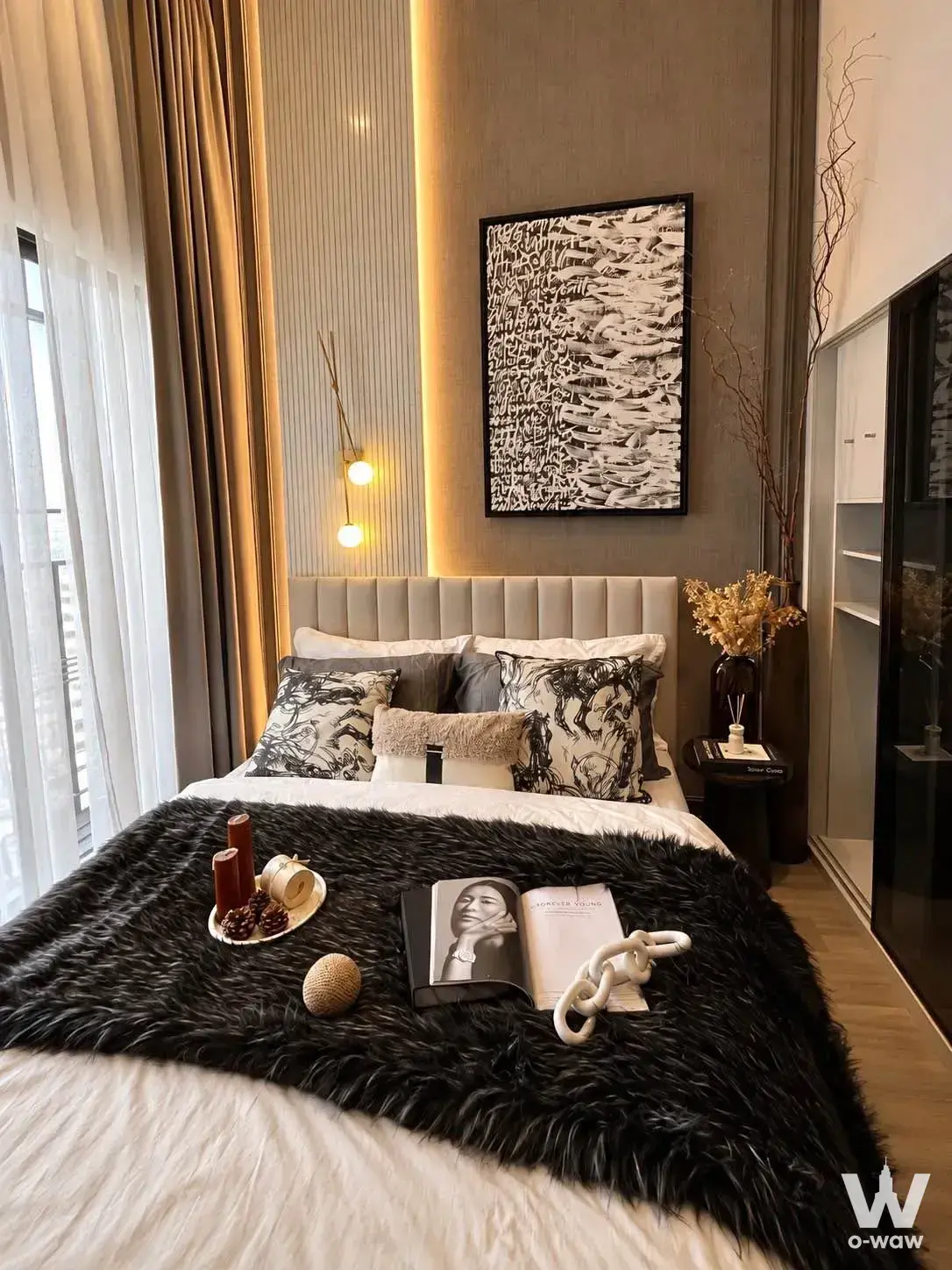 Luxury master bedroom with fluted wood accent wall, amber LED lighting, and staged decor in a 2-bed condo for rent at SOHO