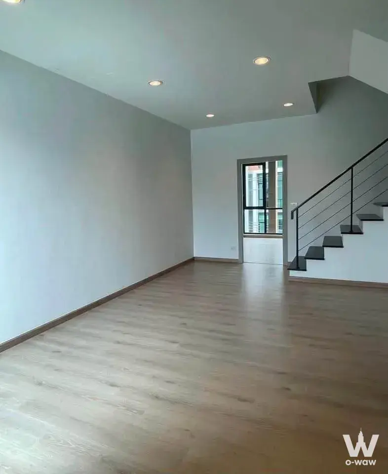 Empty open-plan living area in Premium Place MIX Nonthaburi with floating staircase and minimalist design