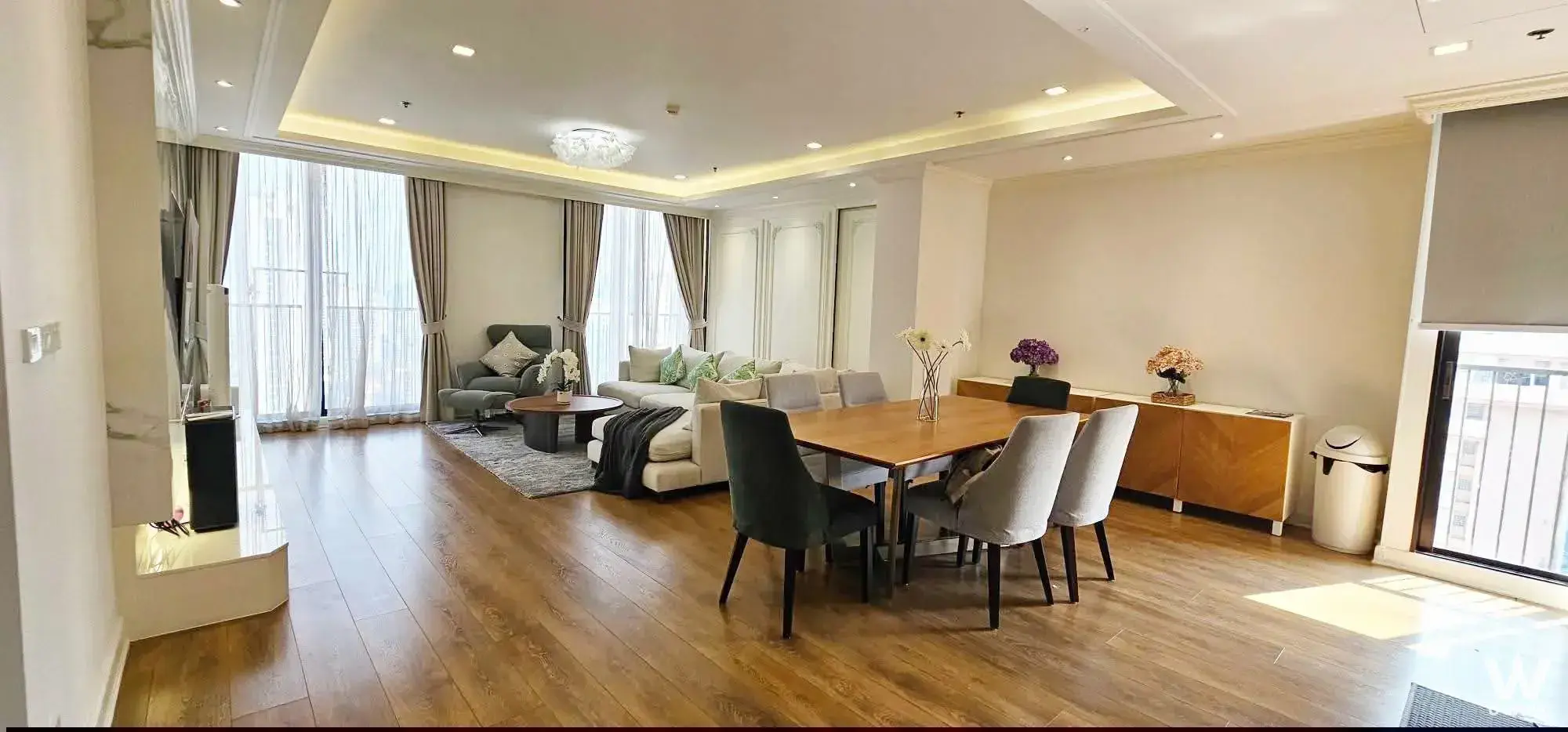 Bright living area in Noble BE33 3-bed condo featuring cream sectional sofa and balcony access