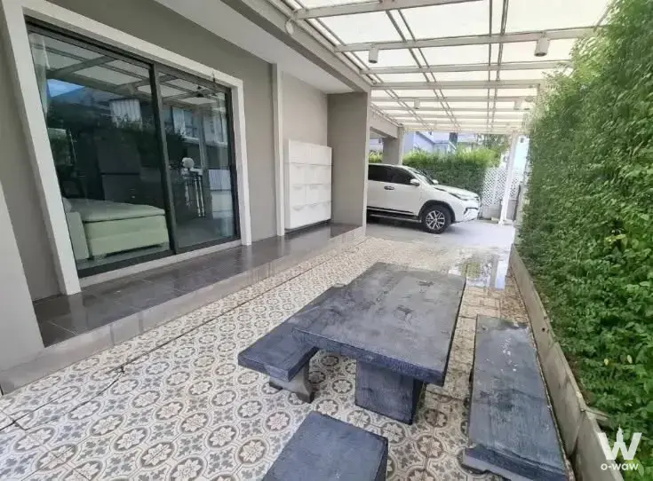 Covered patio with stone dining set and encaustic tile floor in PAVE Pinklao-Salaya