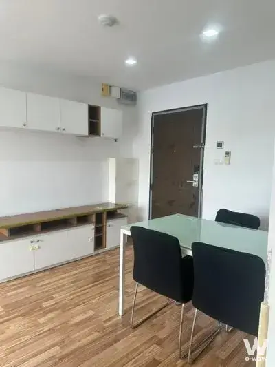 Dining area with white table and built-in cabinetry in 2-bed condo for sale at The Green Condo III