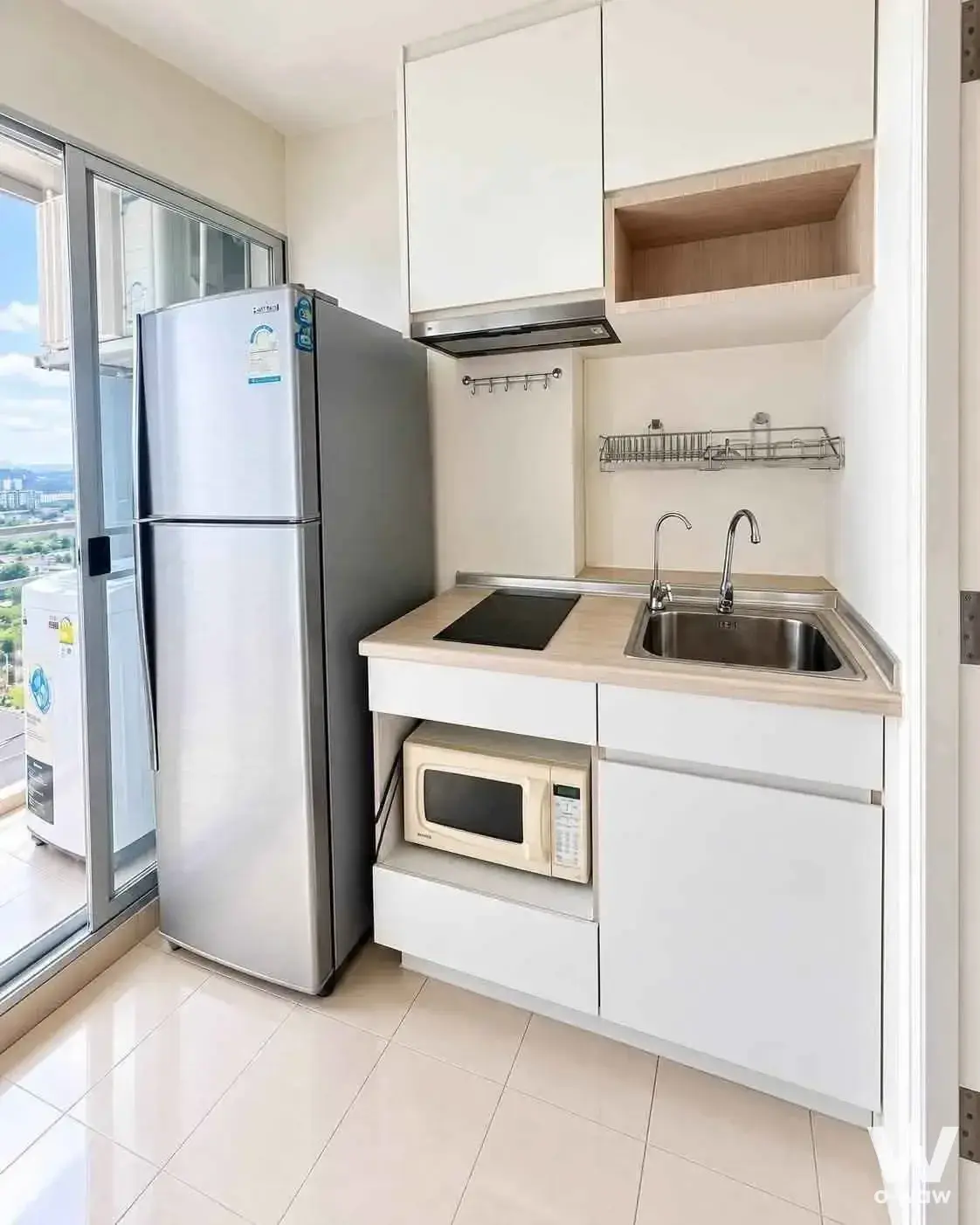 Compact kitchen with balcony view in 2-bed condo for rent at Lumpini Ville Sukhumvit 77-2