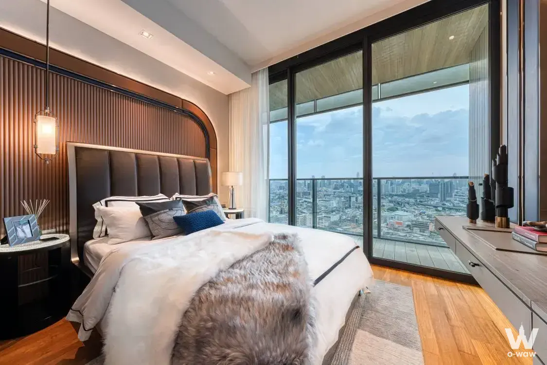 Banyan Tree Residences master bedroom with curved arch accent wall and balcony city views