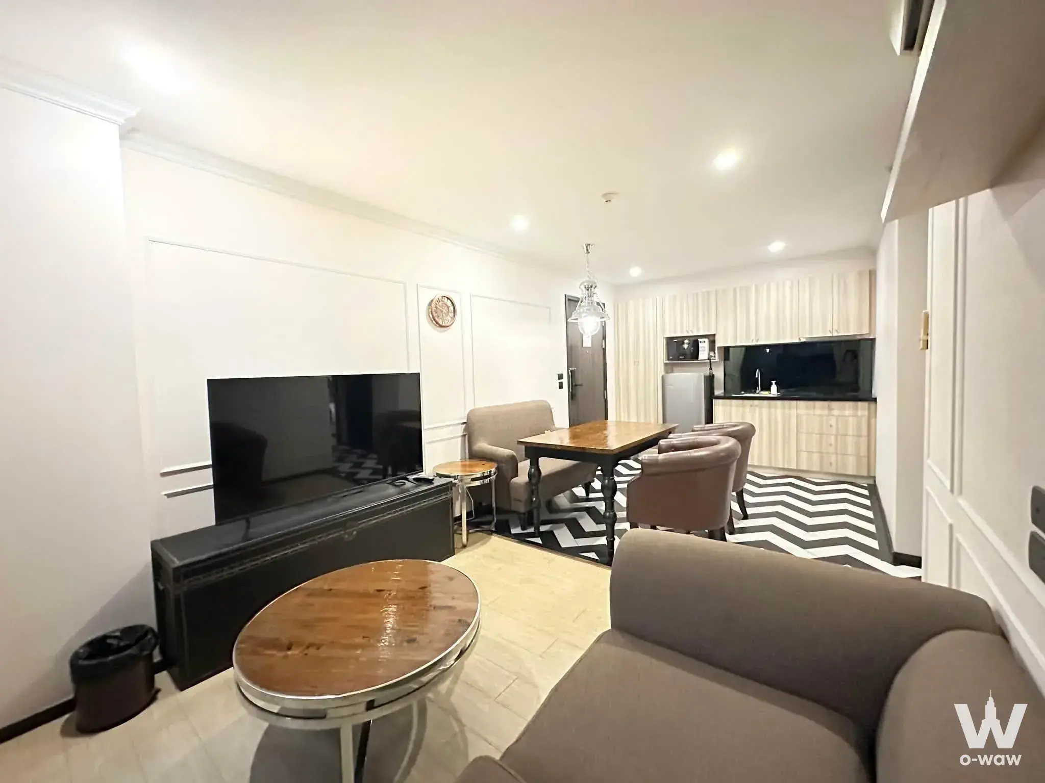 Open-plan condo interior in Venetian Signature Pattaya with chevron tile and crystal light