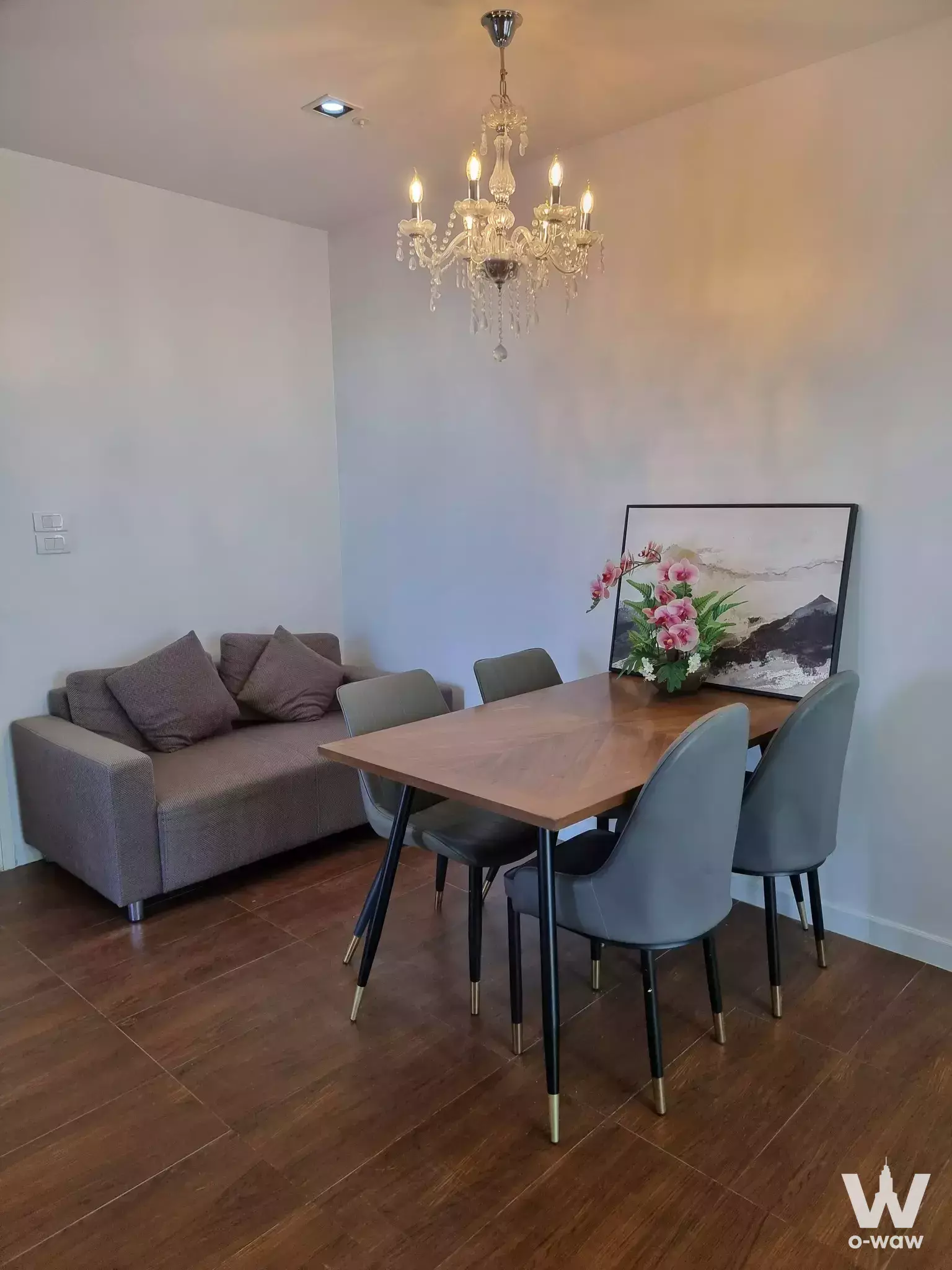Furnished dining area in The Room Sathon-Taksin with crystal chandelier and wooden table