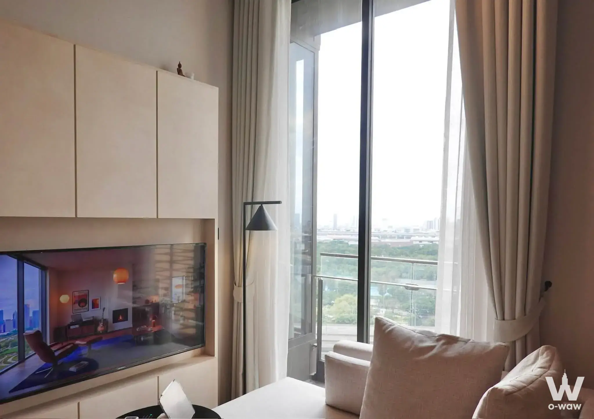 1-bed condo for rent in The Crest Park Residences showing a living room with built-in cabinetry and balcony access