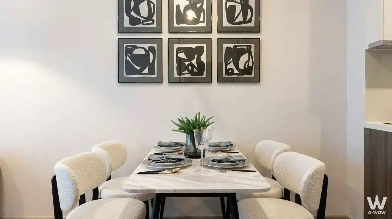 Marble dining table with cream boucle chairs in this 1-bed condo for rent at Celes Asoke