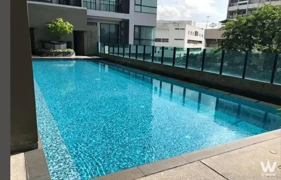 Rectangular lap pool at Premio Vetro with turquoise water, stone deck, and glass safety barrier