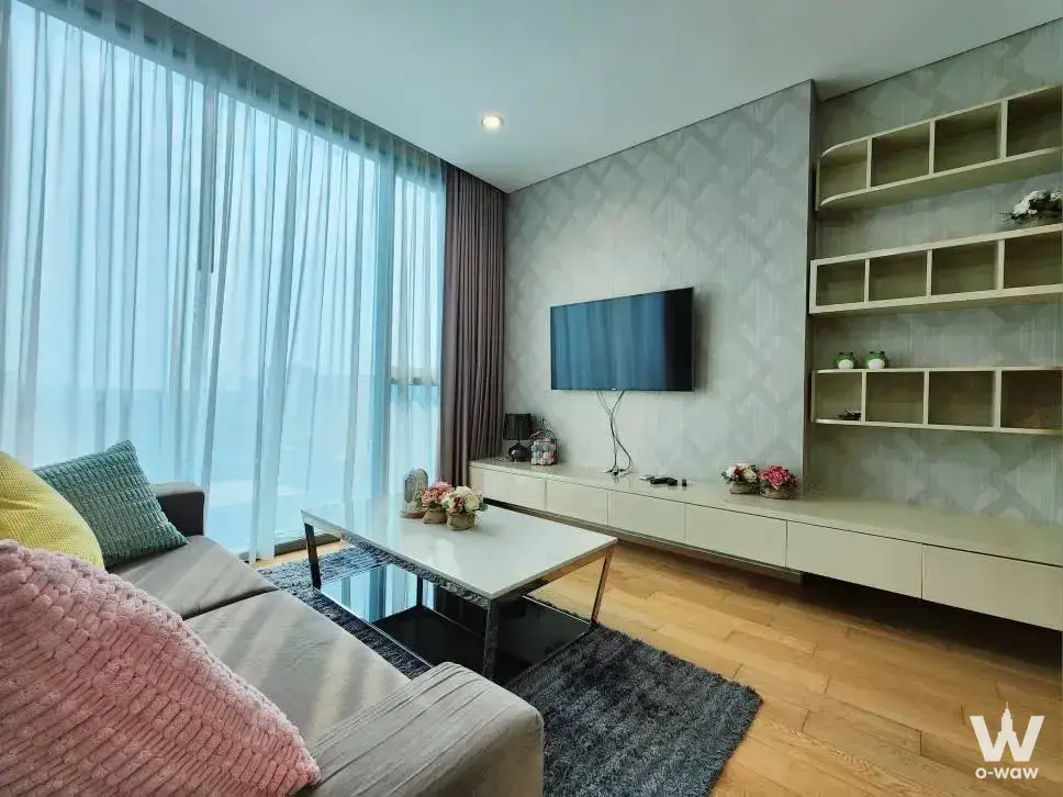 Living room in The Breeze Naradhiwas condo with colorful pillows