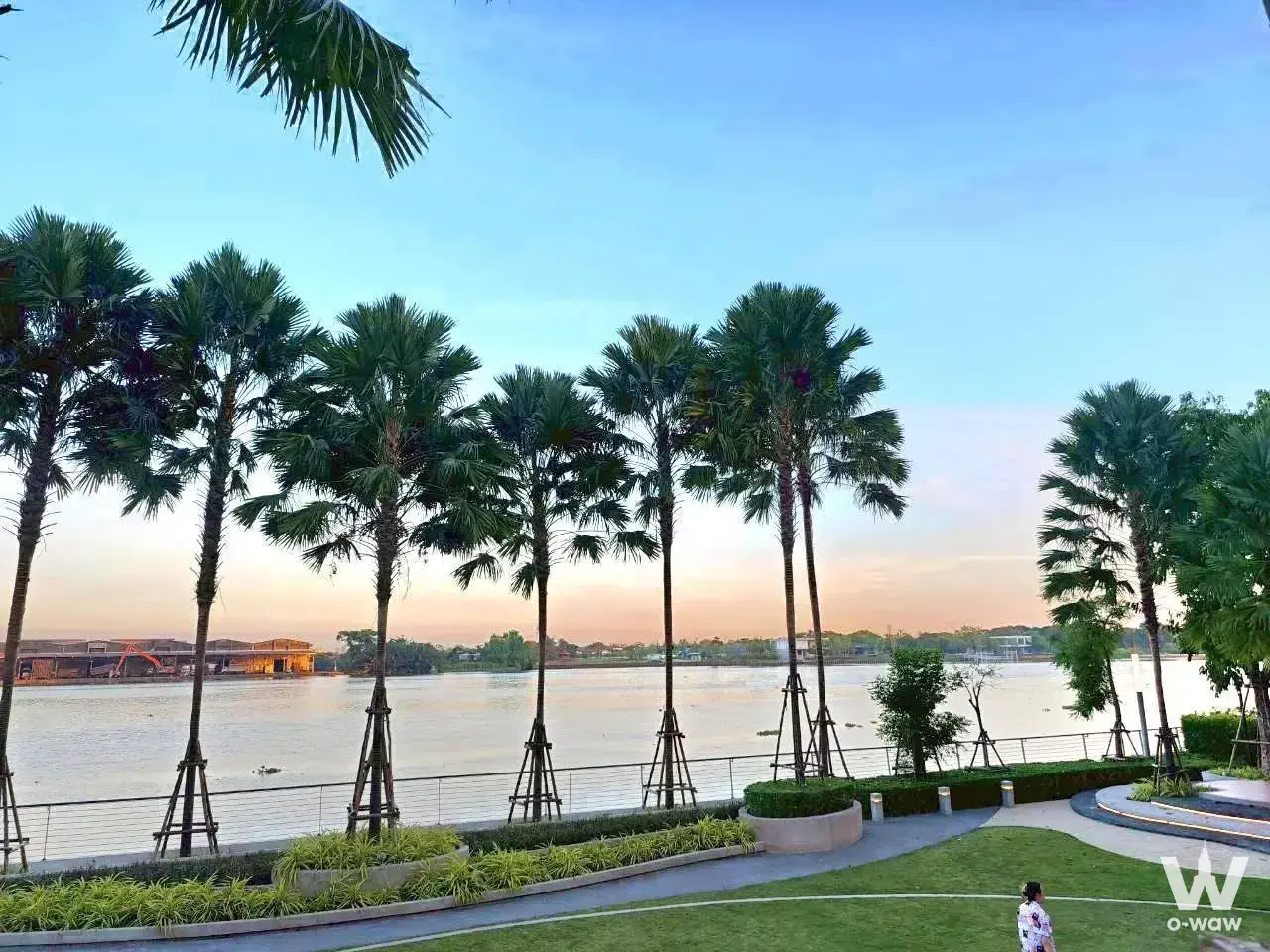 Riverside park amenity at Supalai Riva Grande Rama 3 with sunset palm tree views