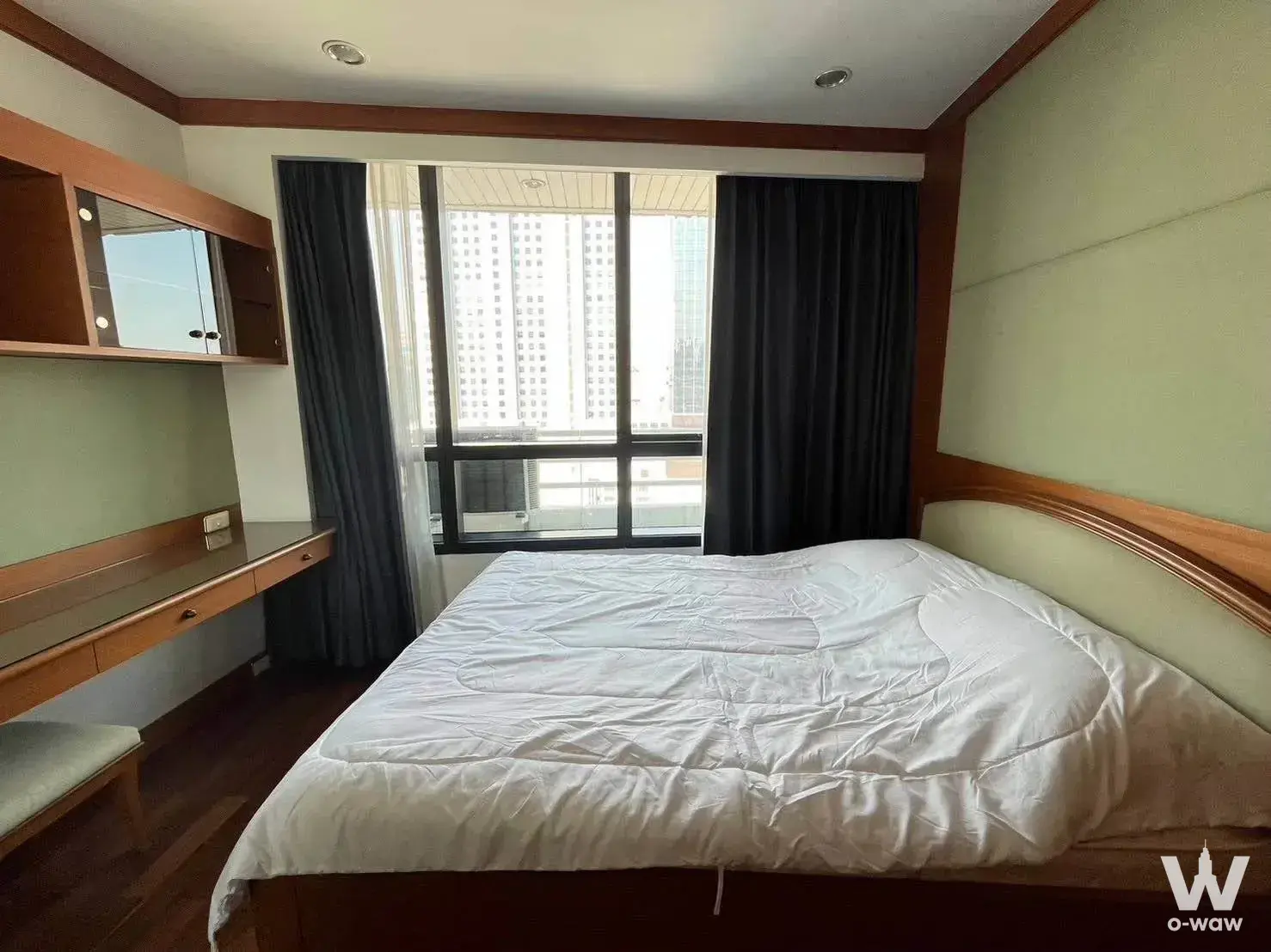 1-bed commercial for rent in President Place master bedroom with sage green walls and desk