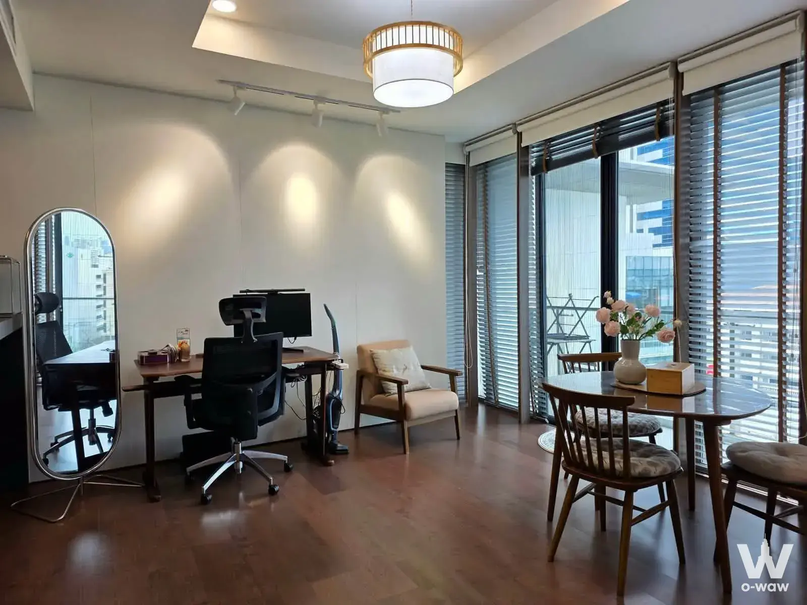 Open-plan home office and dining area with city skyline view through sliding glass doors in Issara@42 condo for sale