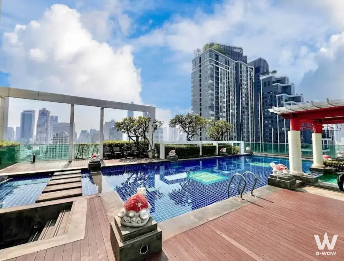 Wish@SamYan rooftop pool deck with wood decking, foo dog statues, and pavilion