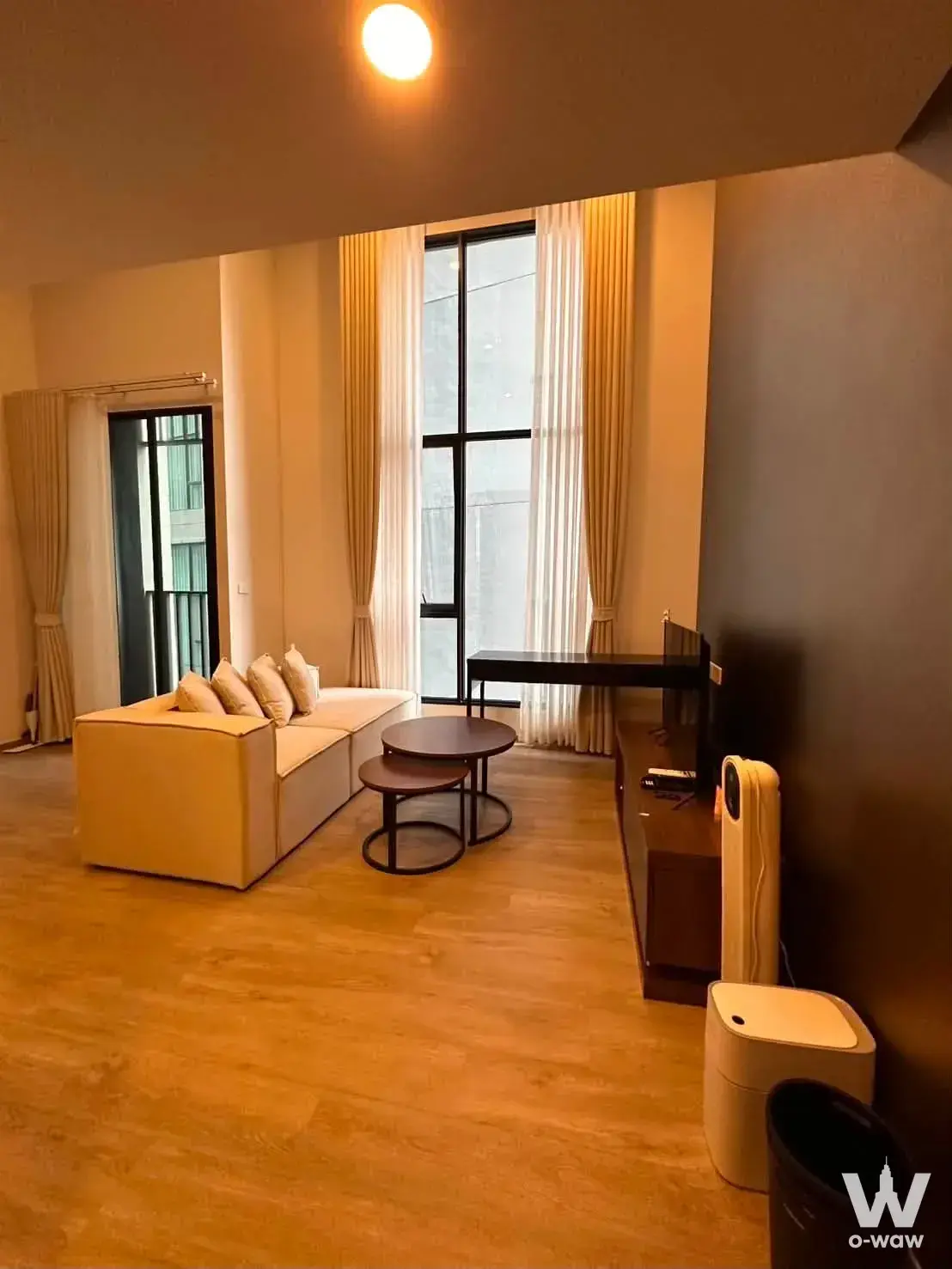 L-shaped sofa and TV console in Ramintra condo for rent