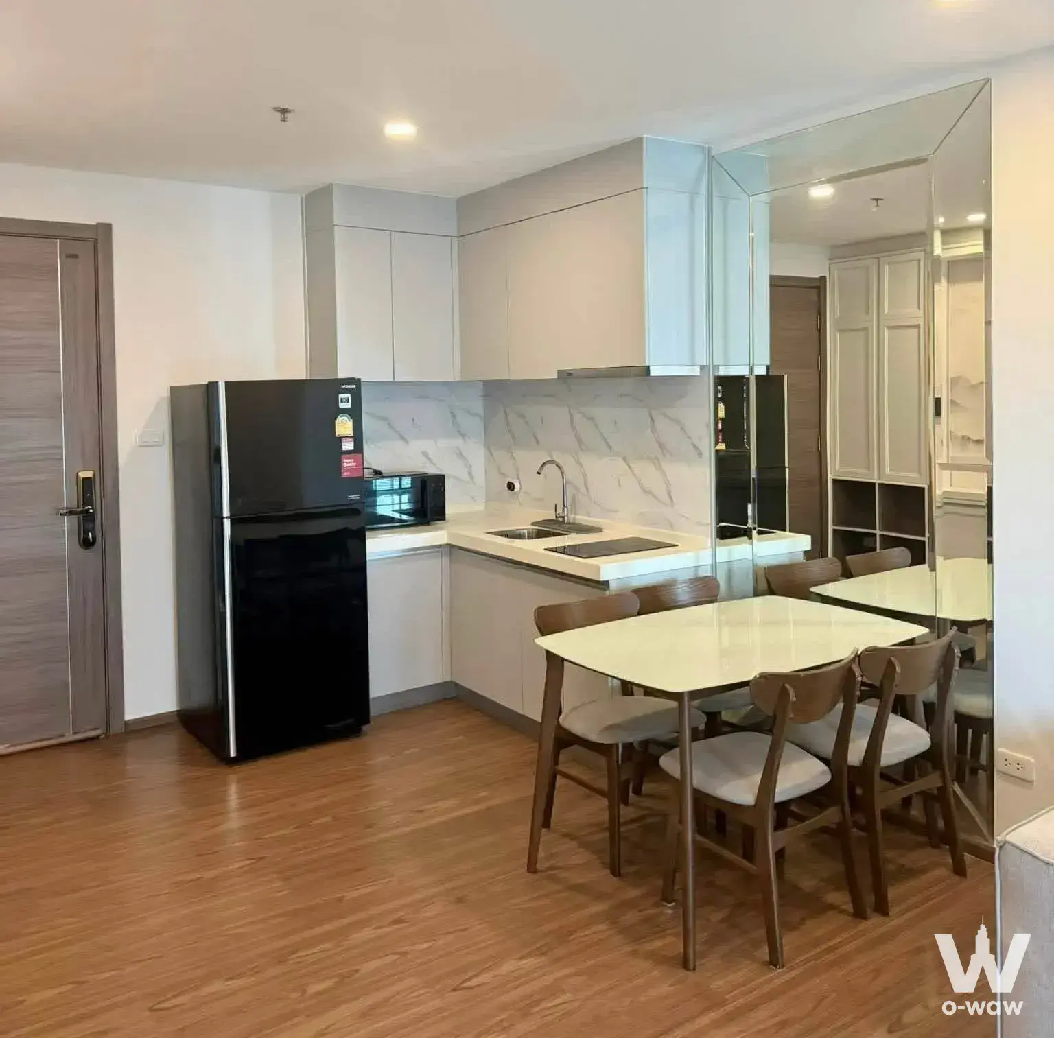 Kitchen and dining space in an Artisan Ratchada 1-bed rental with grey cabinets and smart lock entry door