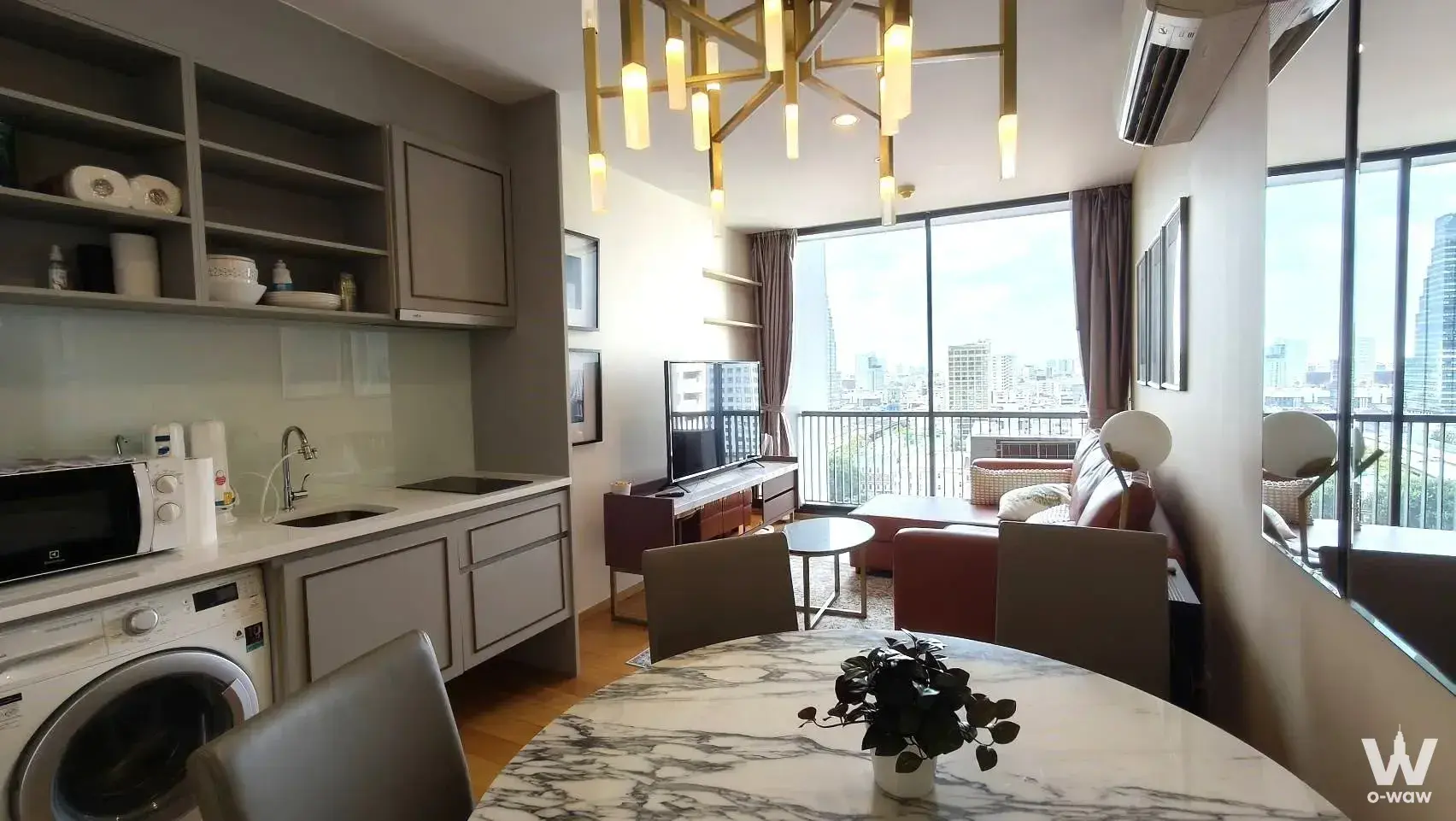 Modern living and dining area with city skyline view in a 2-bed condo for rent at Noble Revo Silom