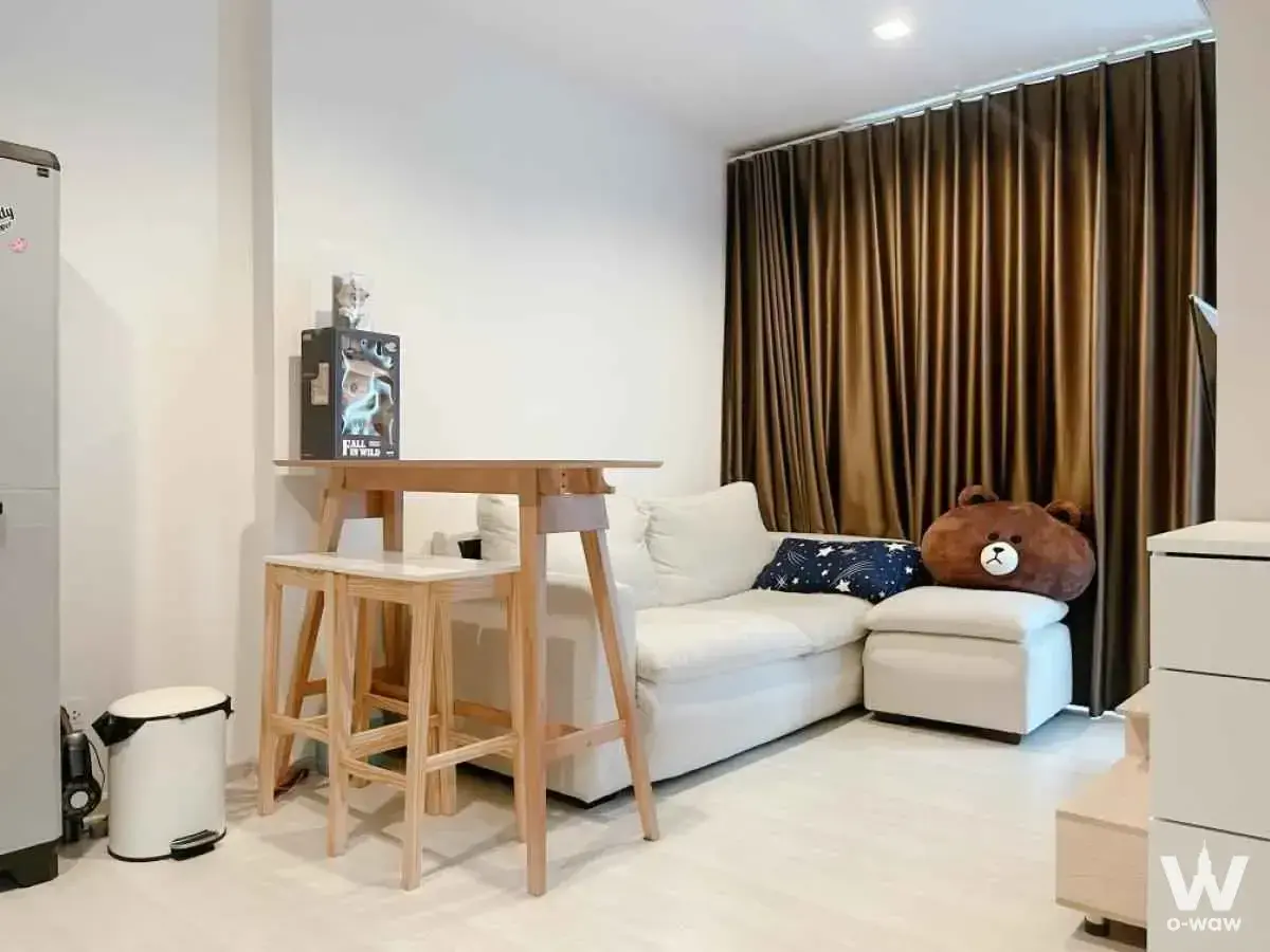2-bed Life Sukhumvit 48 living room with L-shaped sofa and starry pillow