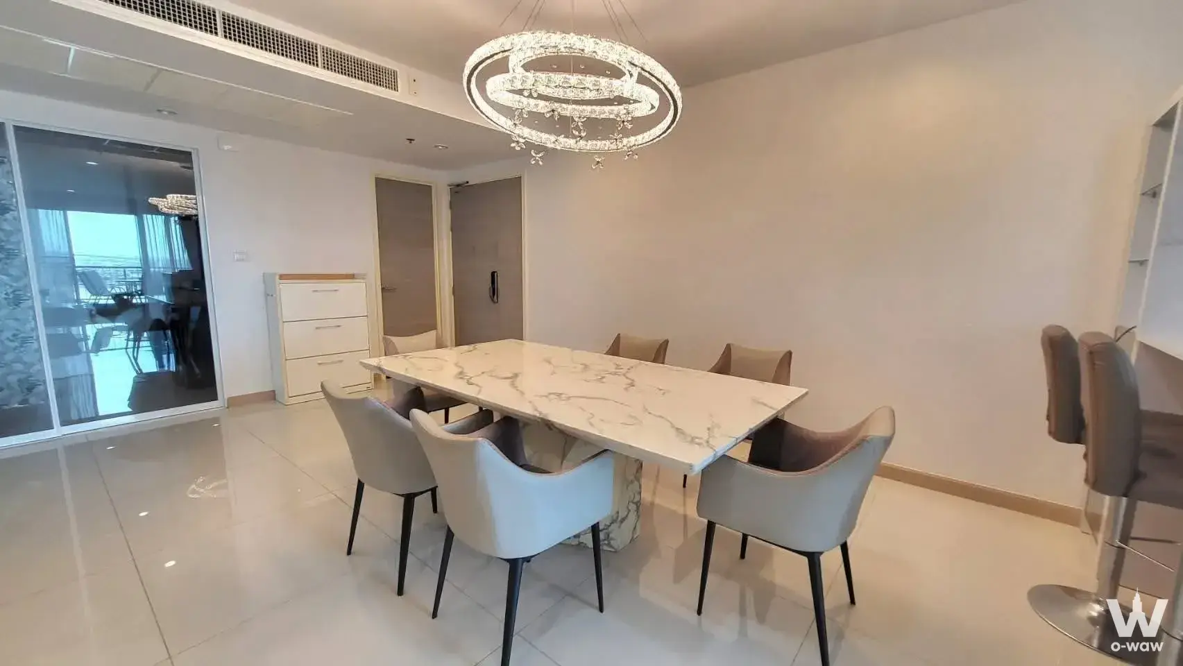 Supalai Riva Grande Rama 3 dining room featuring marble table and crystal chandelier