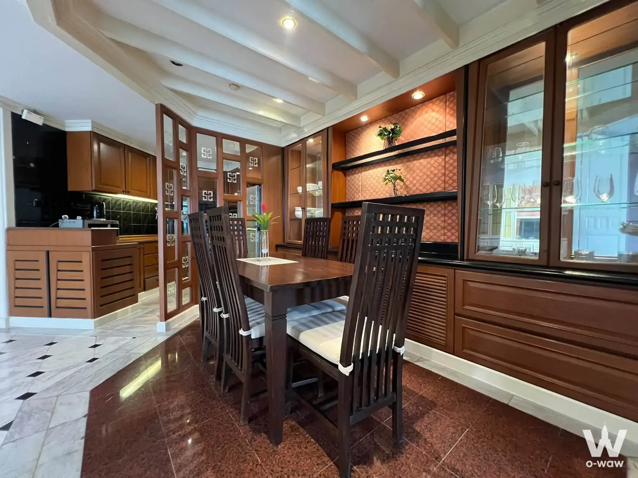 Dining room with dark mahogany set and partition in 2-bed condo for rent at The Park Condominium