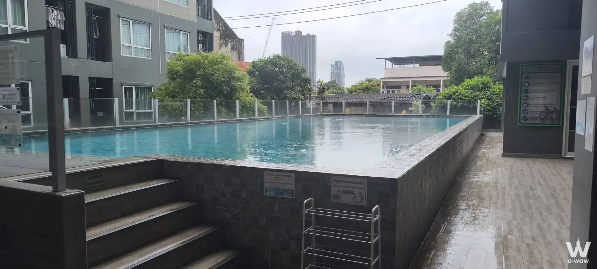 Turquoise pool with wet deck and laundry balconies at Condo Regent Home 7/1 1-bed condo for sale
