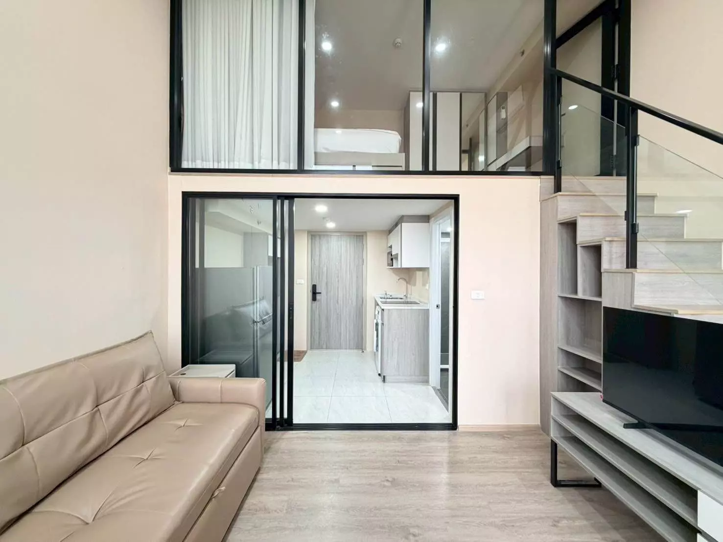Loft studio at Origin Plug & Play Nonthaburi Station with glass partition and mezzanine bed