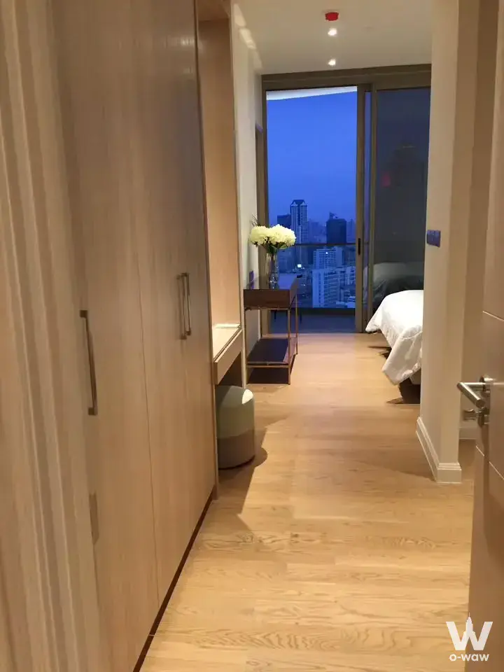 Magnolias Waterfront Residences bedroom hallway with built-in wardrobe and dusk city skyline view