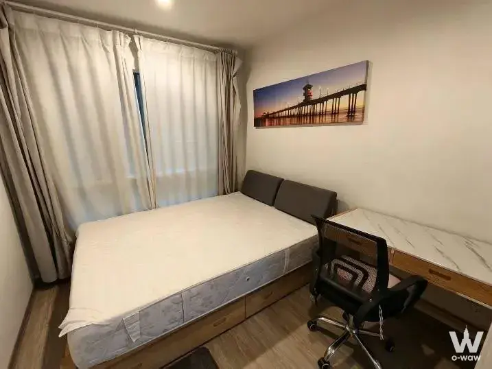Bedroom in Condo Regent Home 7/1 rental with queen bed, sheer curtains, and pier lighthouse art