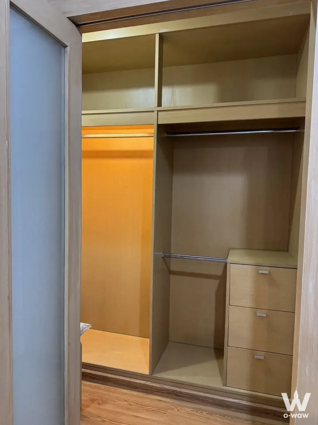 Built-in wardrobe with frosted glass doors and oak cabinetry in The Next Garden Suite