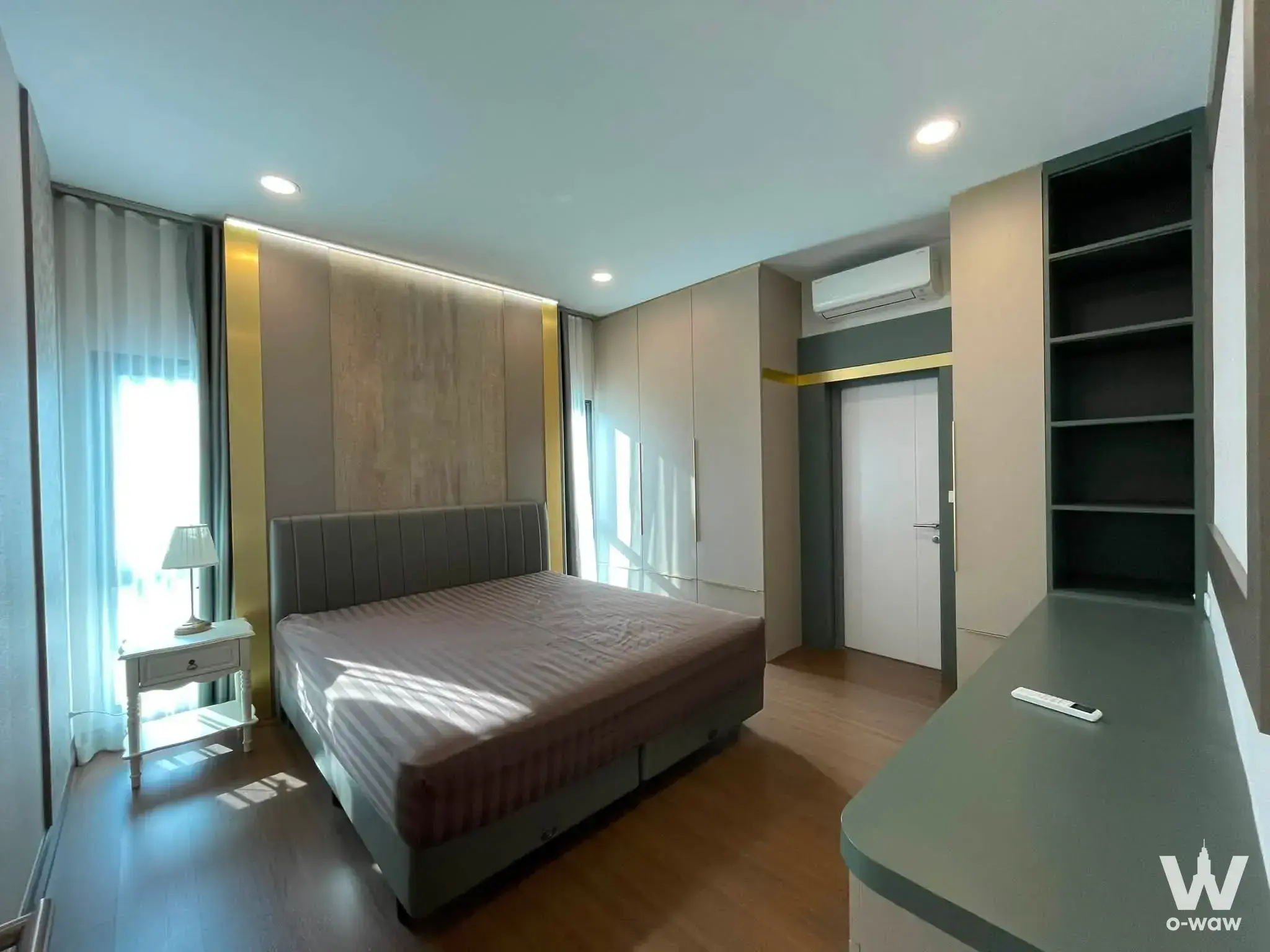 Furnished bedroom featuring wood paneling, gold accents, and a built-in wardrobe in THE CITY Bangna 2
