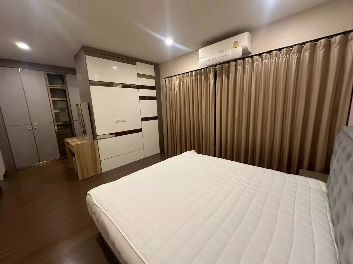 Master bedroom in The City Bangna house featuring built-in wardrobe and vanity