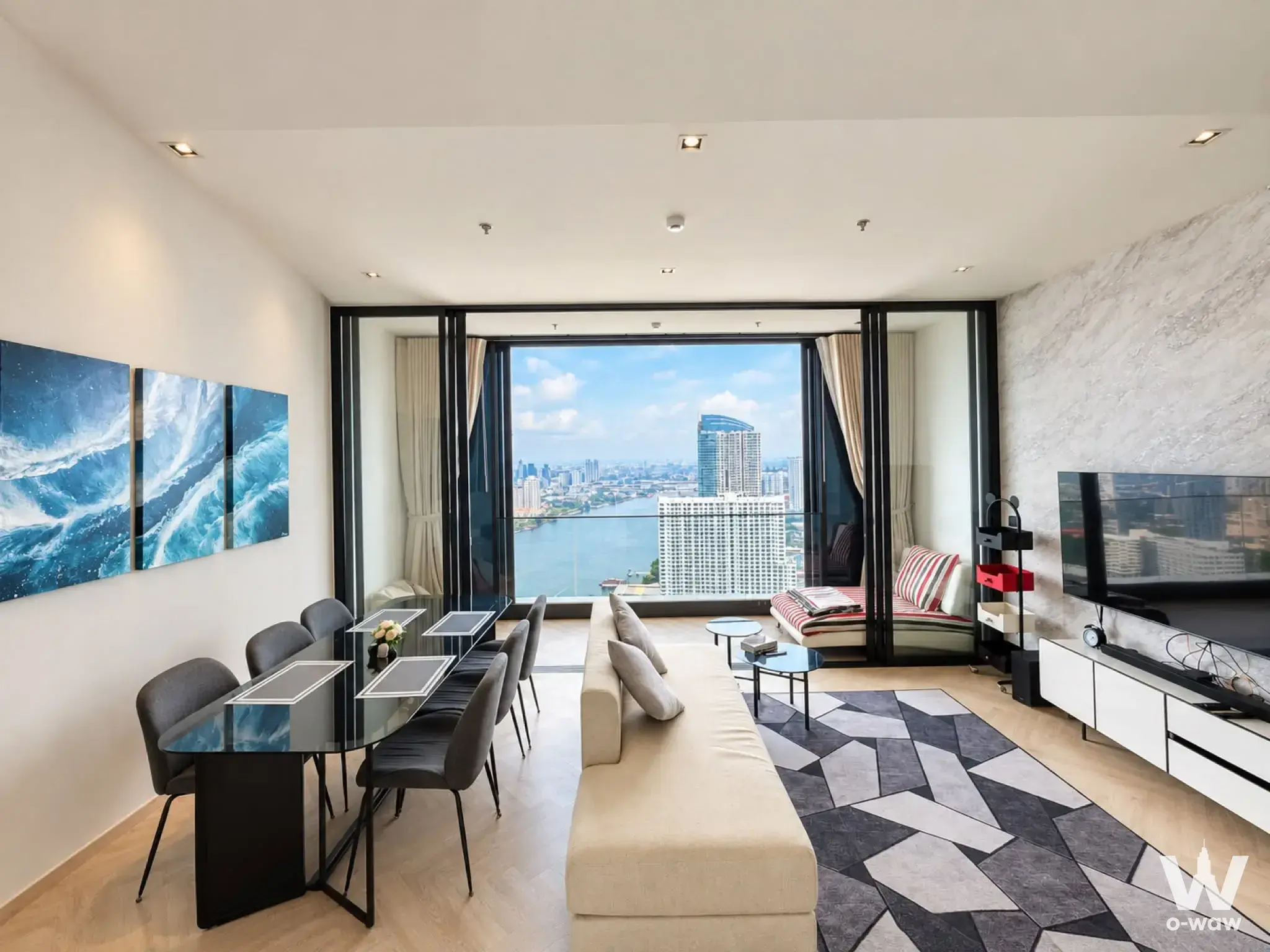 Chapter Charoennakhon living area with open-plan layout, river view, cream sofa, and modern dining set