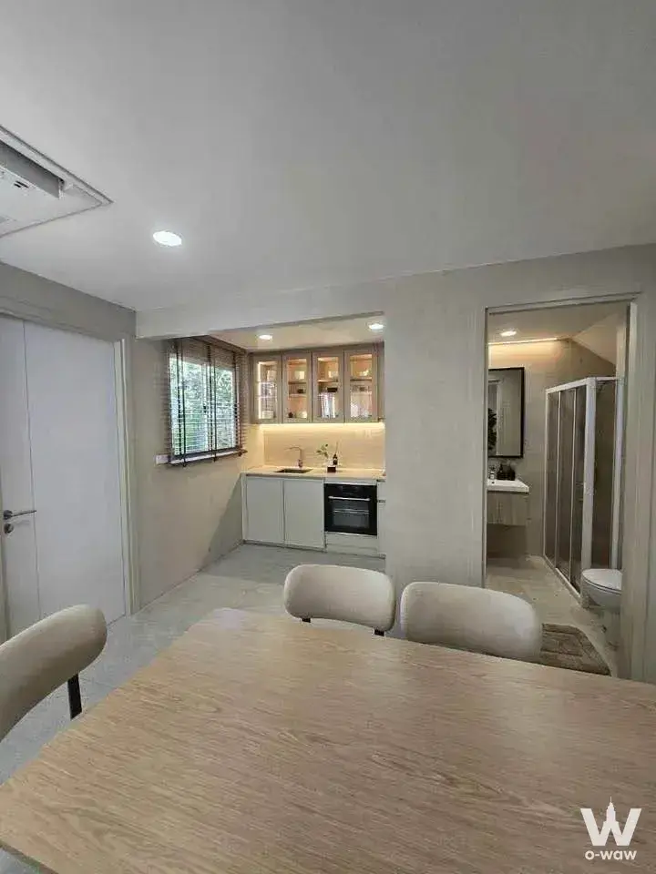 3-bed townhouse dining area in Nue Verse Krungthep Kreetha with open kitchen and bathroom view