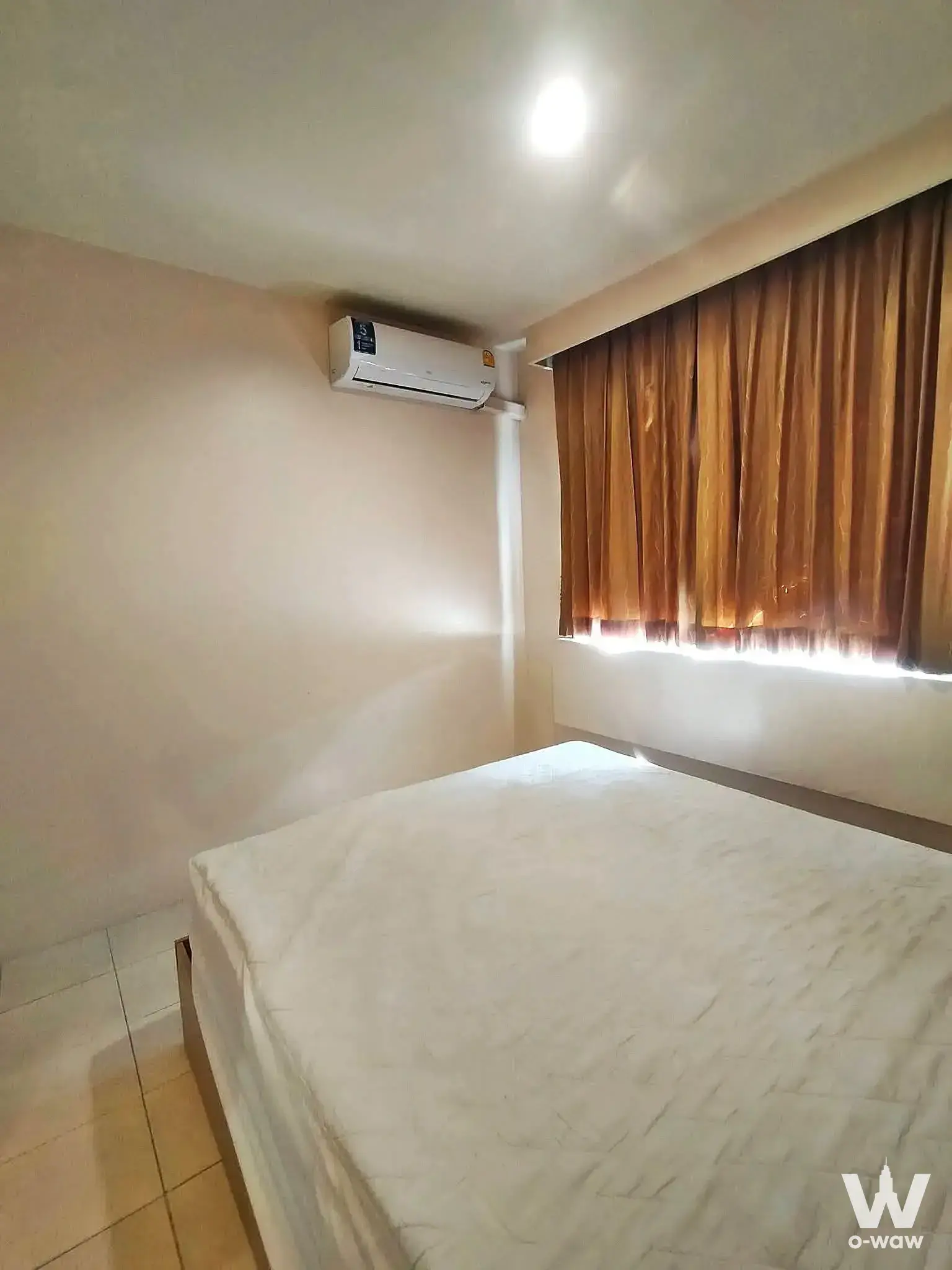 Simple bedroom with queen bed and AC in The Parkland Bangna condo