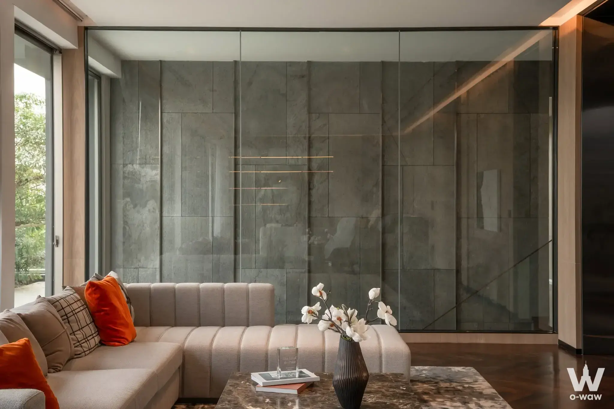Luxury living room in 6-bed Nirvana Collection house with beige sofa and floor-to-ceiling glass