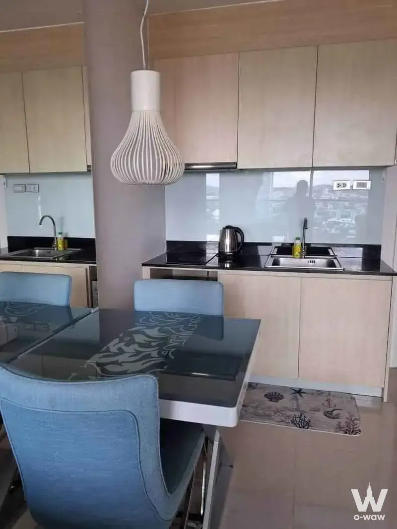 Modern kitchen with black granite counters and dining area at Grande Caribbean Condo