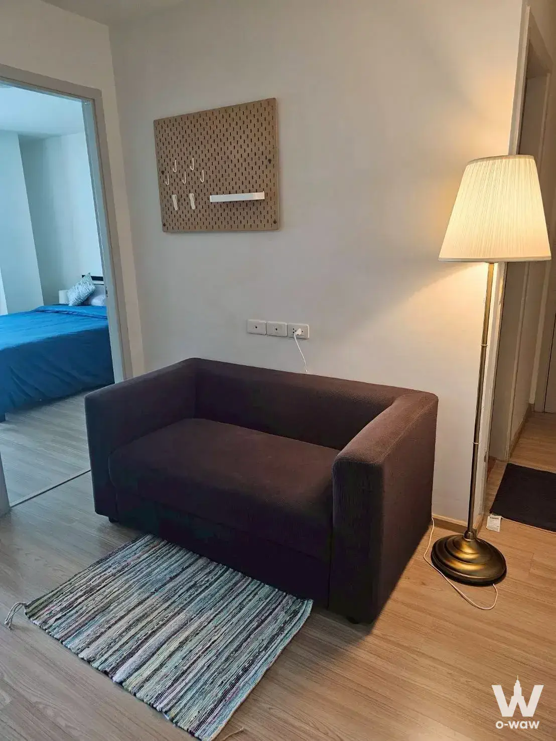 1-bed condo for sale in B-loft sukhumvit 115 studio with modern pegboard organizer, blue-grey rug, and compact layout