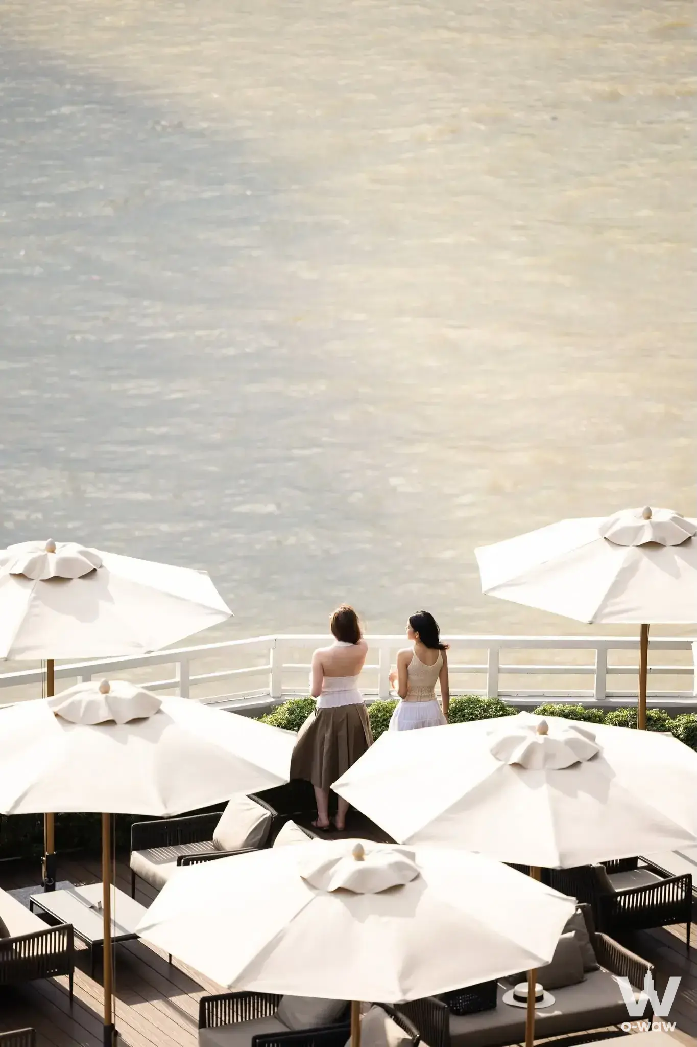 Chatrium Residence Riverside Bangkok 4-bed condo terrace with river view and rattan lounge chairs