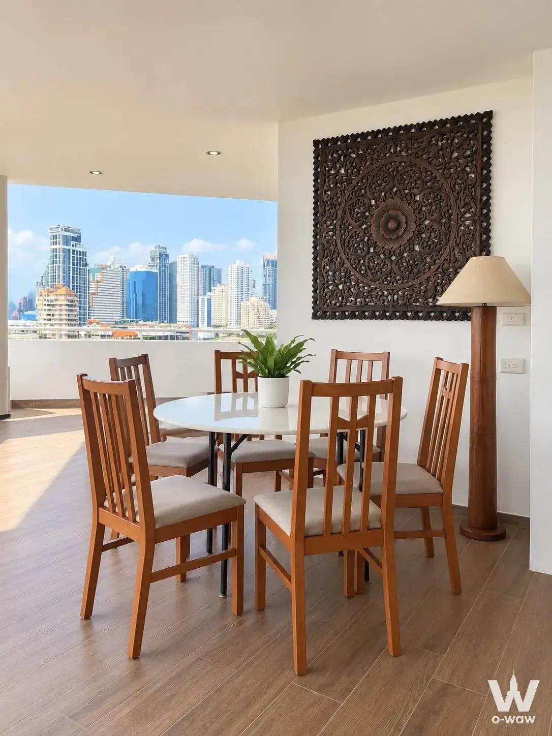 4-bed condo for sale in La Cascade Condo with round dining table and traditional Thai wall art