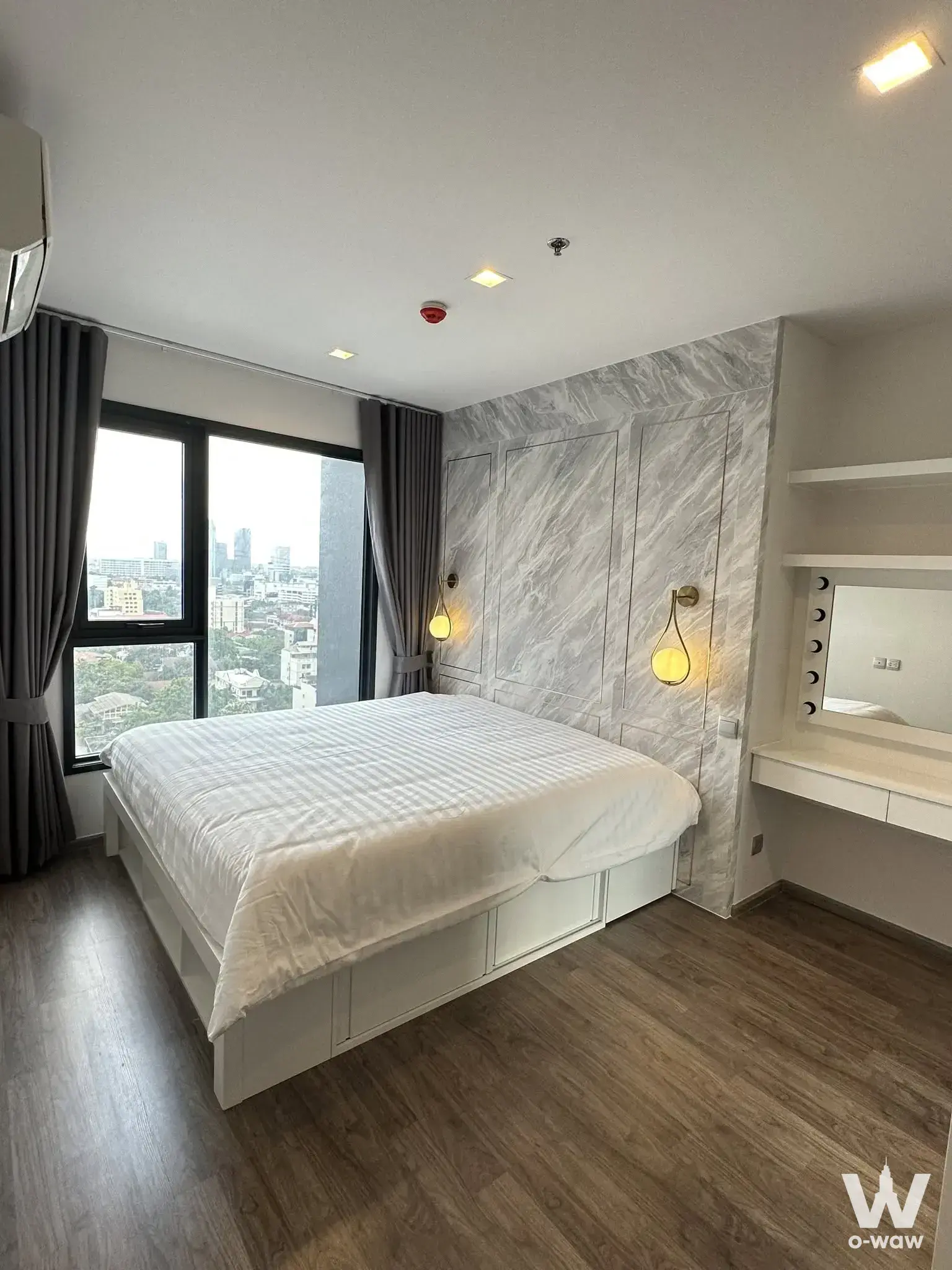 Life Ladprao Valley master bedroom with grey marble feature wall and gold sconces