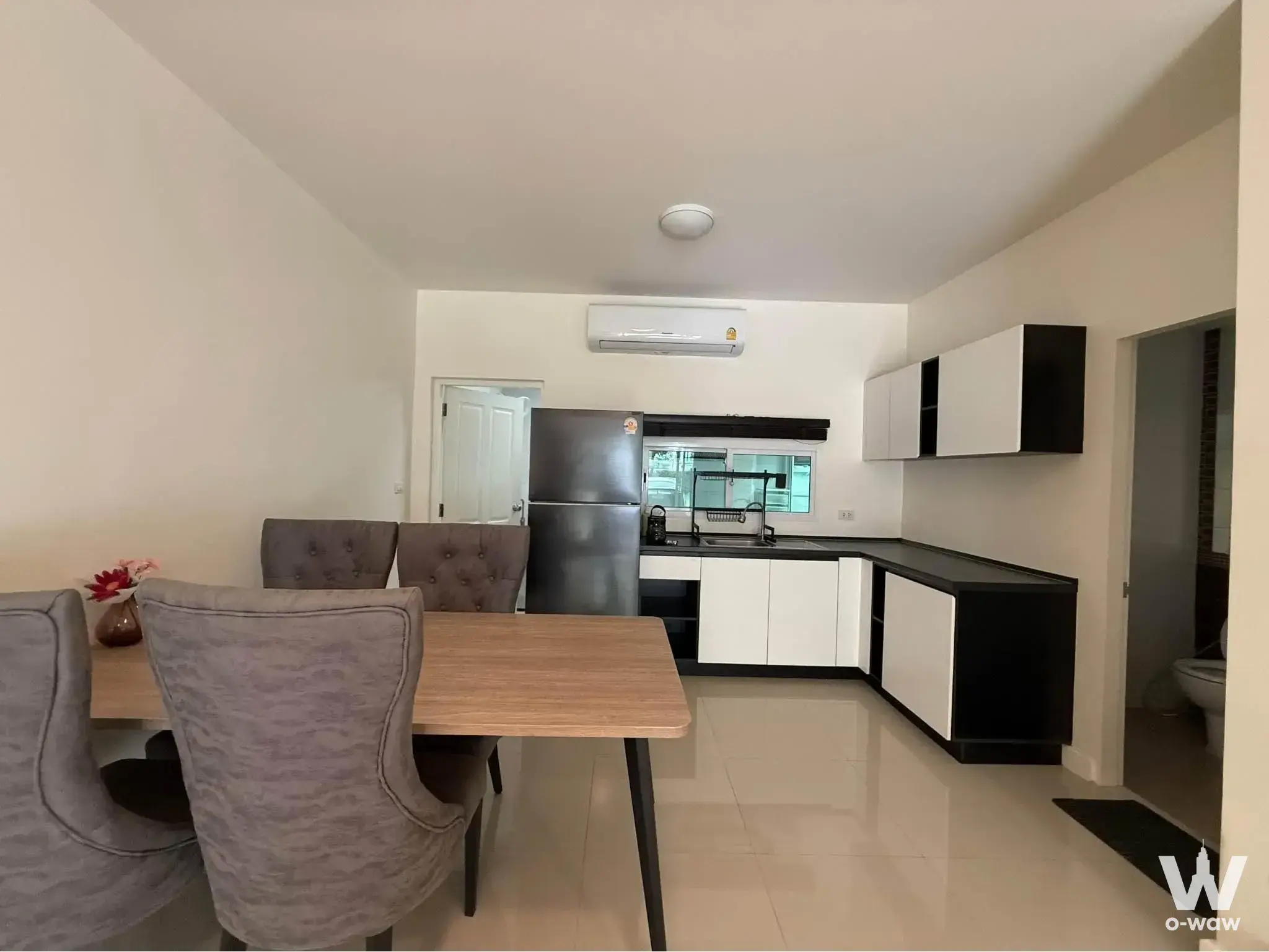 Furnished dining kitchen area in Town Avenue Srinagarindra with grey wingback chairs