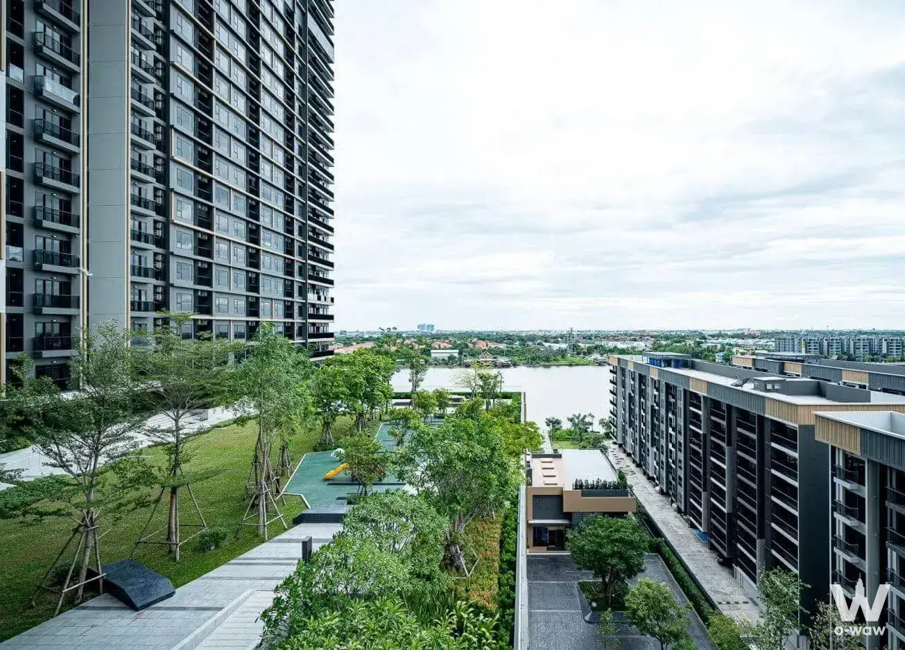 High-rise tower and landscaped garden with playground at The Politan Rive, a 1-bed condo for rent