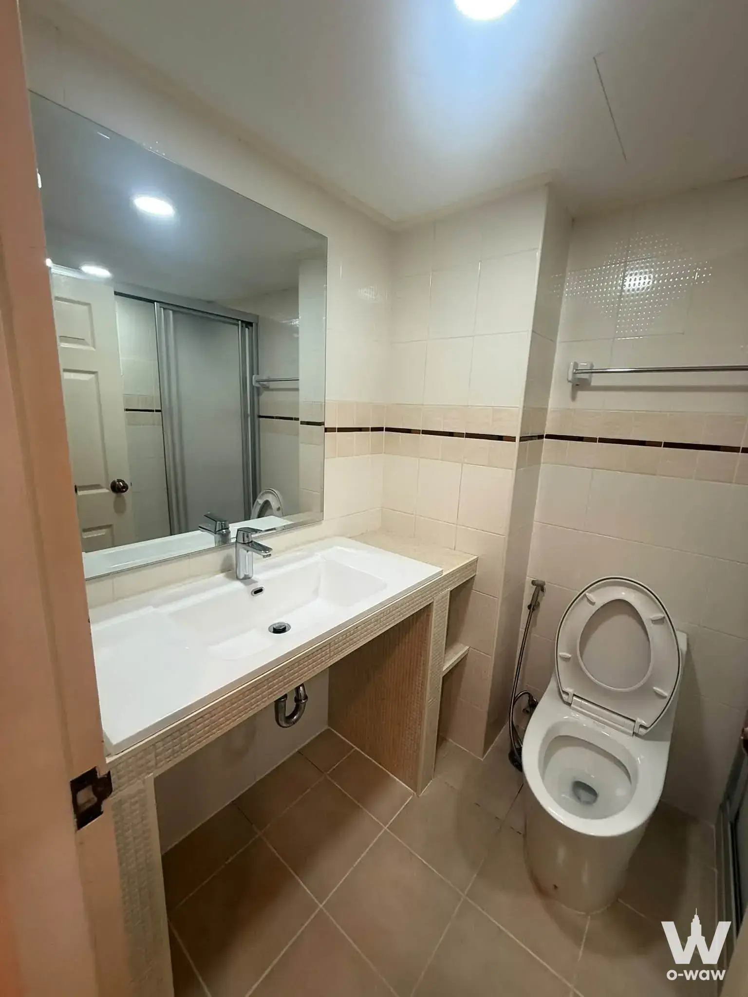 Beige mosaic vanity bathroom with frameless mirror in Lumpini Ville Cultural Center